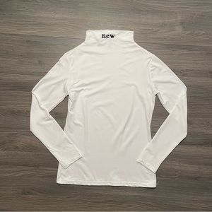 White mock neck long sleeved top